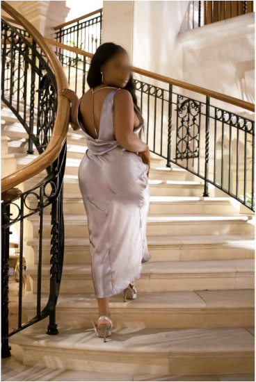 Elegant ebony girl walking up a luxury flight of stairs