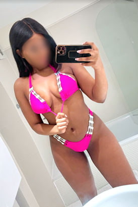 Black girl in a hot pink bikini taking a sexy selfie