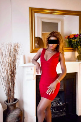 Elegant petite ebony girl in a striking red dress and heels