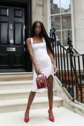 Beautiful slender black girl in a short white dress